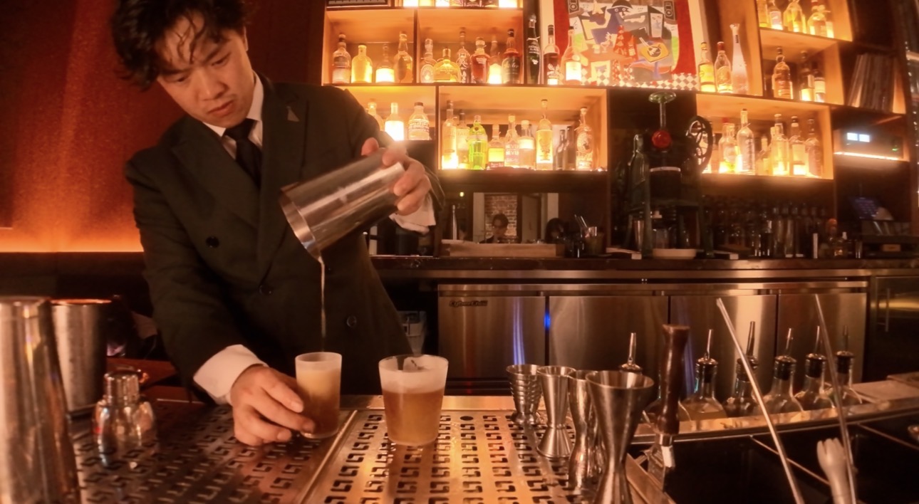 Bartender preparing drinks in front of the Tailor Room backbar